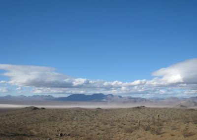 Mojave Desert Mountain Range With Lingering Clouds Above And Dust Storm