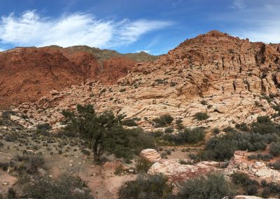 Large Red Rock Formations And Mountain Ranges In Mojave Desert