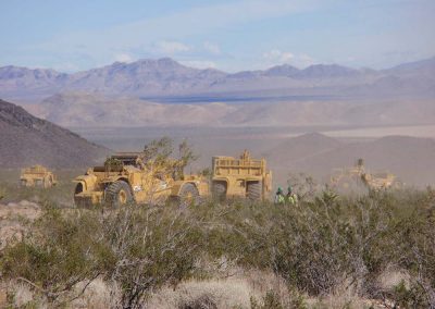 CAT Tractors And Workers Doing Construction Out In The Mojave Desert